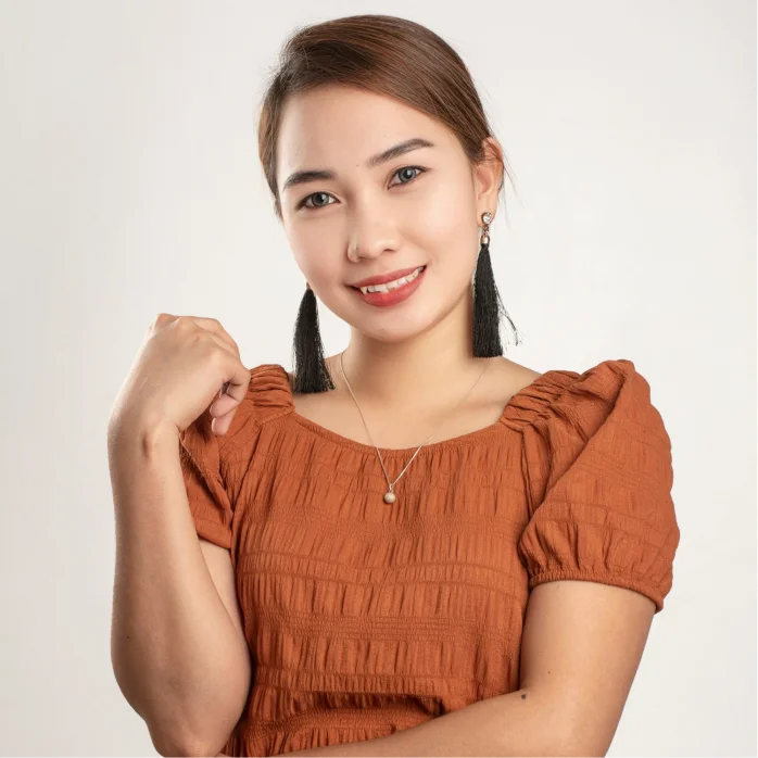Whitney smiling, in an orange top